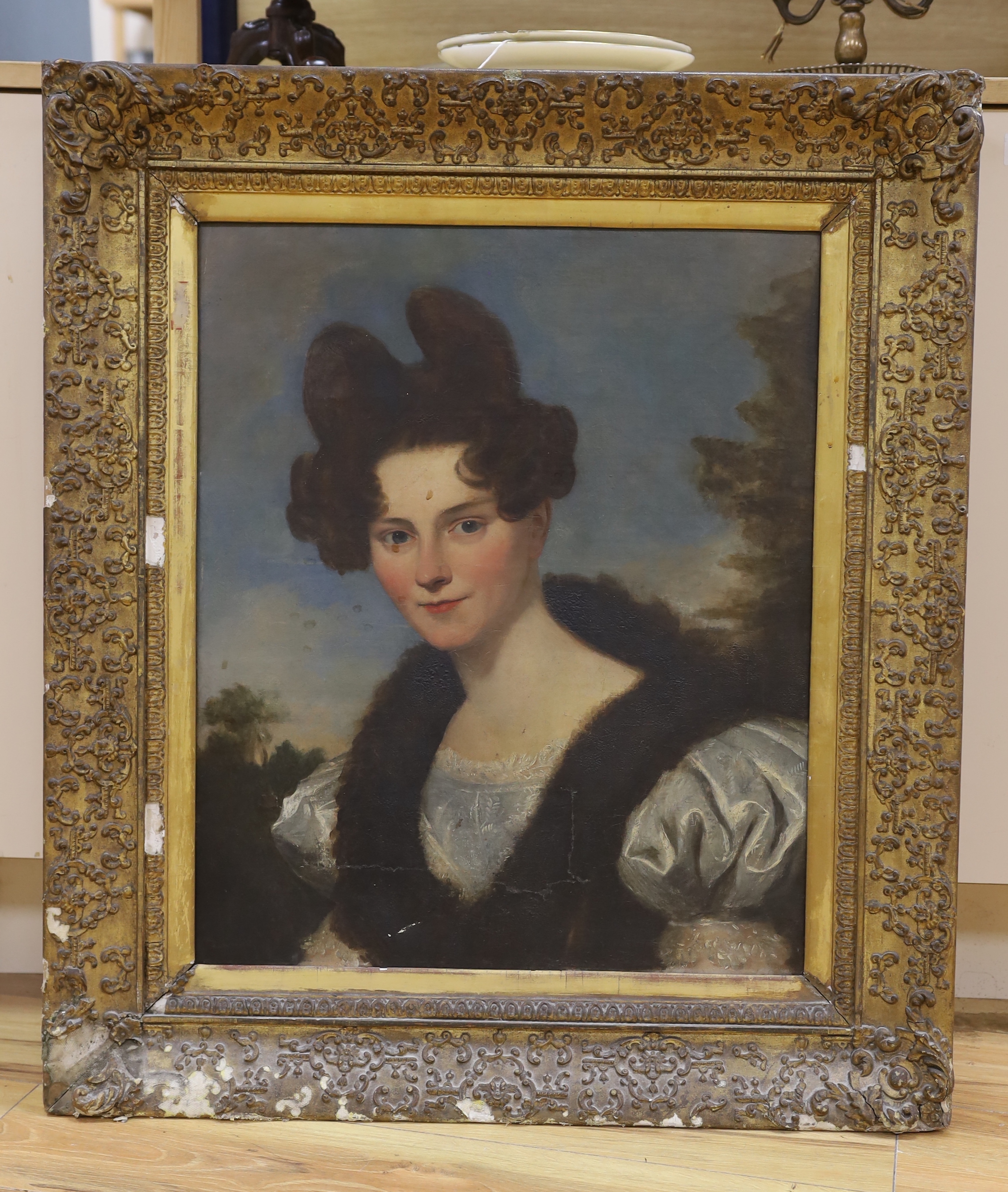 Victorian School, oil on canvas, Head and shoulders portrait of a lady wearing 1830's dress before a landscape, 60 x 50cm (a.f.)